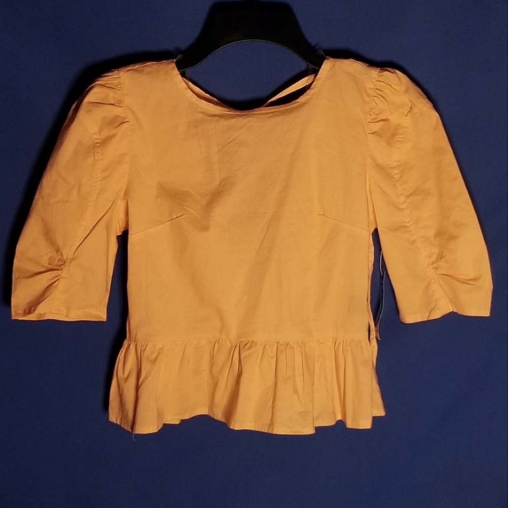 Iky & Me Top With Playful Ruffle Hem Featuring A Flattering Round Neckline
